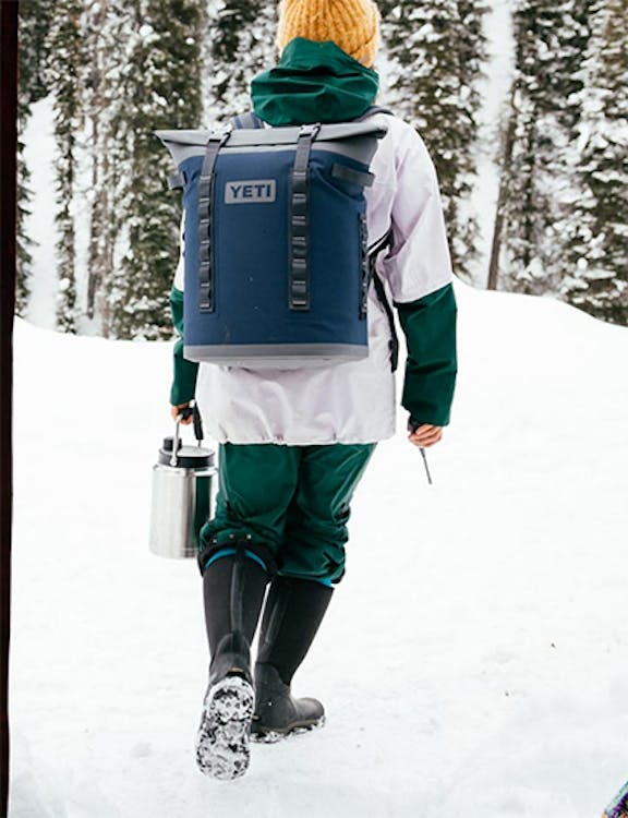 man wearing backpack cooler