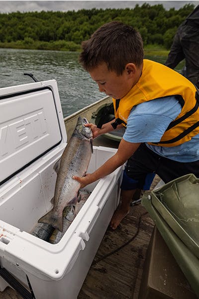 Kid_With_Cooler_And_Hanging_Fish_Strips