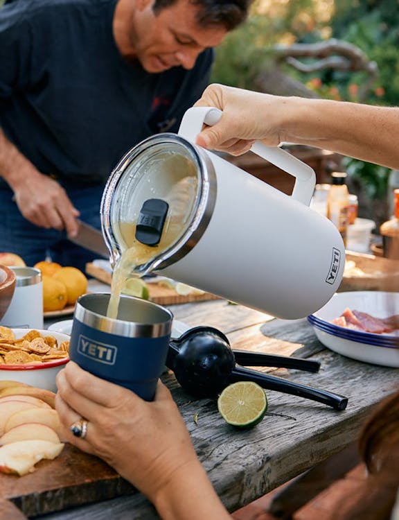 White Pitcher pouring into stackable cup.